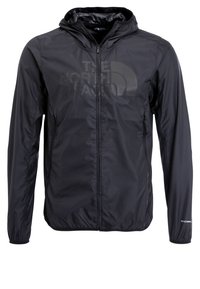 Veste légère noire zippée à capuche, manches longues, avec un logo discret "The North Face" sur la poitrine et un texte "Windwall" sur la manche.