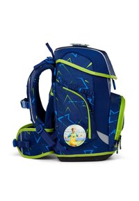 Backpack in dark blue with green accents and a geometric pattern, featuring adjustable straps and a circular patch on the side.