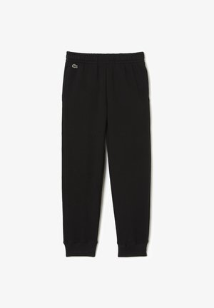 Pantaloni sportivi neri realizzati in tessuto morbido, con una cintura elastica e polsini, dotati di un piccolo logo verde sulla gamba sinistra.