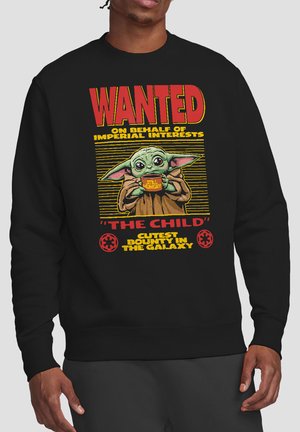 Black sweatshirt with "Wanted" text and illustration of Baby Yoda holding a "Still Hungry" bowl, labeled "The Child" bounty poster design.