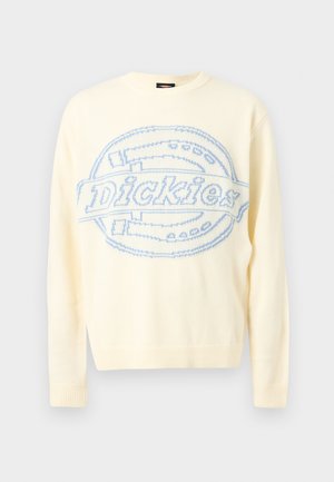 Kremno obarvan pleten pulover z dolgimi rokavi, na sprednji strani z velikim svetlo modrim logotipom "Dickies" in okroglim motivom.