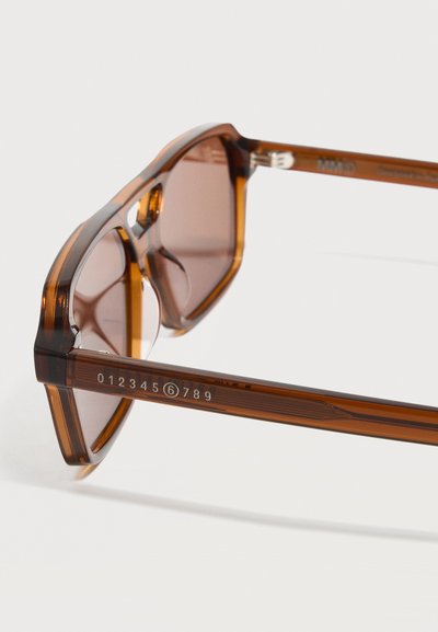 Brown translucent sunglasses with angular frames and numbers 0 to 9 printed on the temple arm on a white background.