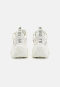 White chunky sneakers with rounded design, textured rubber sole, mesh accents, and printed branding on pull tabs.