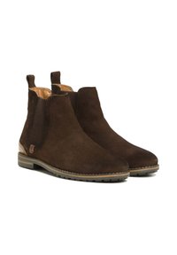 Bottines en daim marron avec panneaux latéraux élastiques, bout rond et semelles en caoutchouc. Présente un accent beige au niveau du talon. Texture lisse.