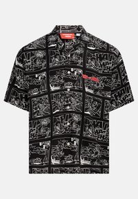 Short-sleeve button-up shirt in black with white comic strip patterns featuring "Tom and Jerry" logo in red. Lightweight fabric, relaxed fit.