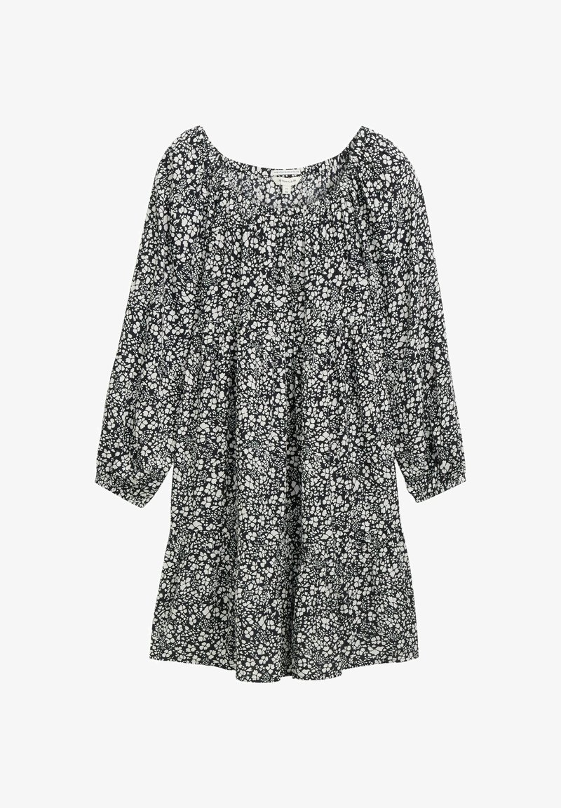 Must mustavest, millel on valge lillemuster, pikad puffi varrukad ja kokku kogutud kaelus. Valmistatud kergest kangast vabalt voolava silueti jaoks.