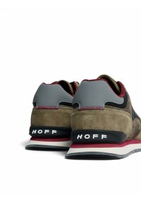 Baskets en suède marron et gris avec une bande rose, présentant un design texturé, une semelle en caoutchouc et un logo "HOFF" sur le talon.