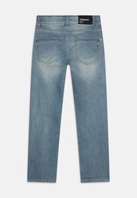 Vaqueros de denim azul claro, con un corte recto, dos bolsillos traseros y un ligero desgaste. La etiqueta muestra el nombre de la marca Vingino.
