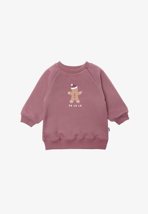 Pink sweatshirt with long sleeves, ribbed cuffs, and hem. Features a gingerbread figure graphic with "FA LA LA" text in white below. Soft texture.