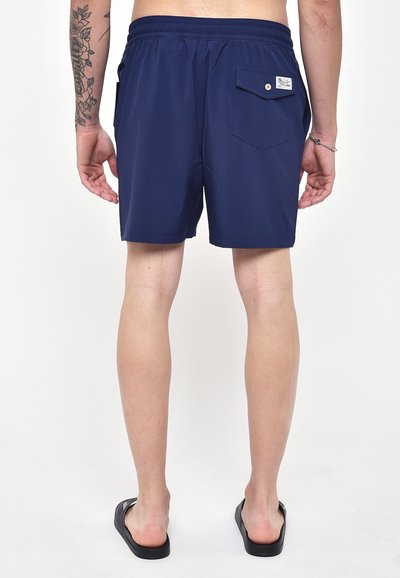 Pantaloni da bagno da uomo di colore blu navy con cintura elastica, tasca posteriore con bottone a pressione e un tessuto liscio e leggero.