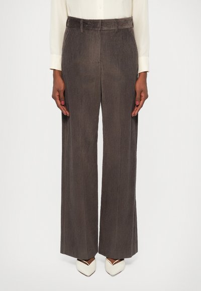 Gray corduroy wide-leg pants with vertical ribbing, a belt, and subtle texture, paired with white pointed-toe shoes.