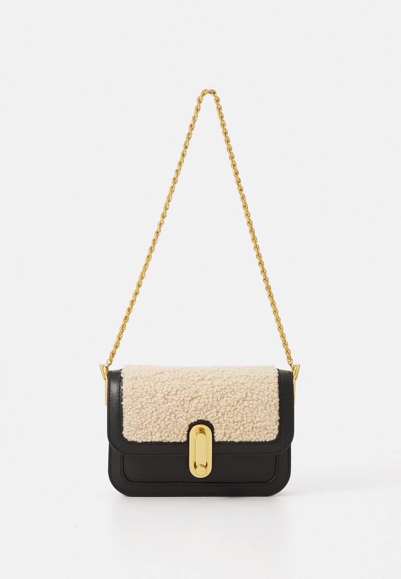 Black leather shoulder bag featuring a cream shearling flap, gold hardware, and a chain strap. Structured design with a rectangular shape.
