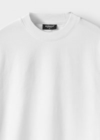 White crewneck T-shirt with ribbed collar and a black label reading "BUROCS BUILT TO LAST M" at the neck inside center.