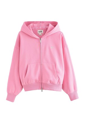 Ružová mikina na zips s prednými vreckami, rebrovanými manžetami a lemom, s kapucňou a malým logom „self.“ na hrudi.