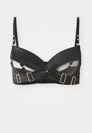 Czarny stanik o satynowym wykończeniu z przezroczystymi panelami z siateczki. Posiada złote akcesoria i krzyżujące się ramiączka, co nadaje mu unikalny design. Regulowane ramiączka na ramionach.