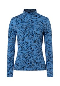 Blue long-sleeve turtleneck top featuring black floral and leaf outlines in a smooth fabric. Simple, fitted design with a high neckline.