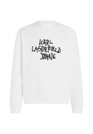 Bijela dukserica s dugim rukavima, koja sadrži crni izvezeni logo "KARL LAGERFELD JEANS" u stilu grafita na prsima.