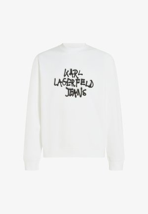 Fehér, hosszú ujjú pulóver, amelyen a mellkason egy fekete hímzett "KARL LAGERFELD JEANS" felirat található graffitis stílusban.