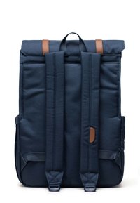 Navy blue backpack with two wide straps, a top handle, and brown leather accents. Features a clean, structured design and durable fabric.