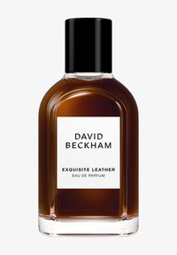 Bottiglia di profumo in vetro marrone con tappo nero. L'etichetta presenta uno sfondo testurizzato bianco con testo nero: "DAVID BECKHAM EXQUISITE LEATHER EAU DE PARFUM."