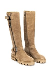 Botas de ante color beige hasta la rodilla con suelas gruesas y robustas. Cuentan con una cremallera lateral, una correa ajustable con hebilla y una textura suave.