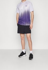 Camiseta deportiva de color púrpura con un degradado, de manga corta, y pantalones cortos negros. Zapatillas negras con suelas blancas y calcetas blancas. Ropa deportiva casual.