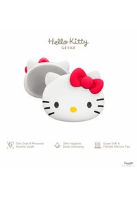 Hello Kitty rengöringsapparat i vitt med en röd rosett, utrustad med mjuka silikonspetsar och en texturerad baksida för djup rengöring.