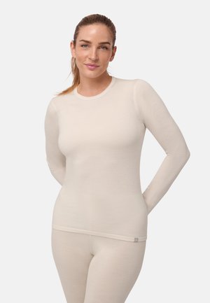 Krémový dlouhý rukáv termální top vyrobený z měkké, ribbed tkaniny, s kulatým výstřihem a přiléhavým střihem. Lehká, elastická textilie.