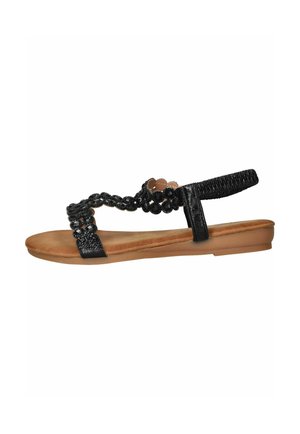 Zwarte platte sandaal met een beige gevoerde zool, versierd met zwarte kralen en een elastische enkelband voor een veilige pasvorm.