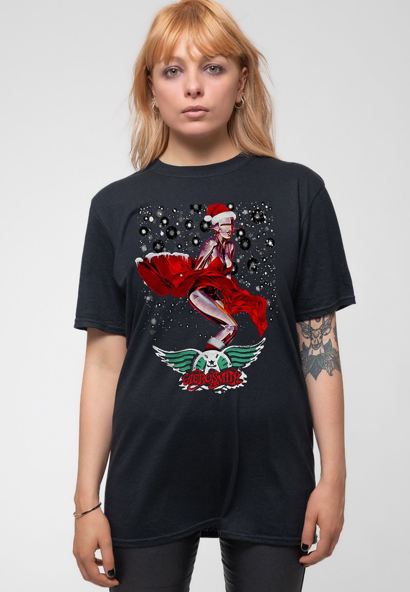 Black cotton t-shirt featuring a vibrant, graphic print of a character in a red dress with a Santa hat, accented by white and green details.