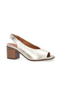 Metallic sølv åben tå slingback sko med en blokhæle, der har en glat tekstur og en rund form. Blød inderside med en let kurve.