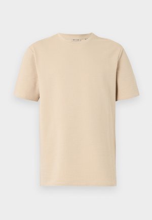 T-shirt beige en maille texturée à manches courtes avec encolure ronde, présenté à plat sur fond blanc.