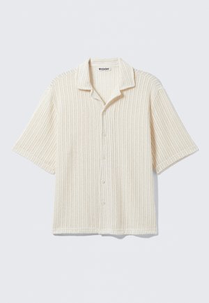 Short-sleeve button-up shirt in cream with a ribbed texture. Features a folded collar and five front buttons. Casual design.