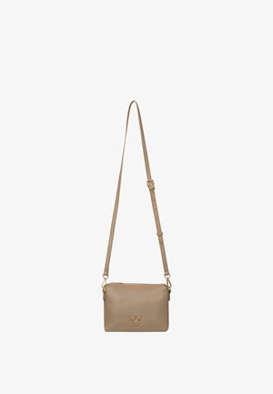 Beige leather crossbody bag with adjustable strap, zip closure, and gold logo accent on the front. Smooth texture with minimalistic design.
