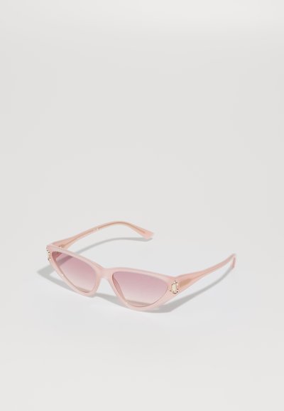 Rosa Kunststoff Katzenaugen-Sonnenbrille mit Verlaufslinsen, ausgestattet mit goldenen Akzenten an den Bügeln. Glatte Textur und spitzes Rahmendesign.