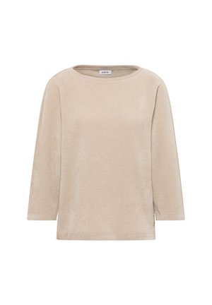 Pull en beige clair avec des manches trois quarts, col rond, tissu texturé, fentes sur les côtés et une petite étiquette de marque sur l'ourlet inférieur.