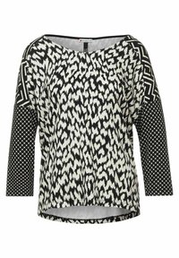 Black and white top featuring animal print with geometric patterned sleeves, boat neckline, and a curved hem. Made from lightweight fabric.