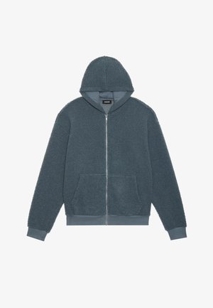 Hoodad zip-up sweatshirt i mörk teal, tillverkad av mjukt, texturerat tyg. Har två framfickor och ribbade ärmslut och nederkant.