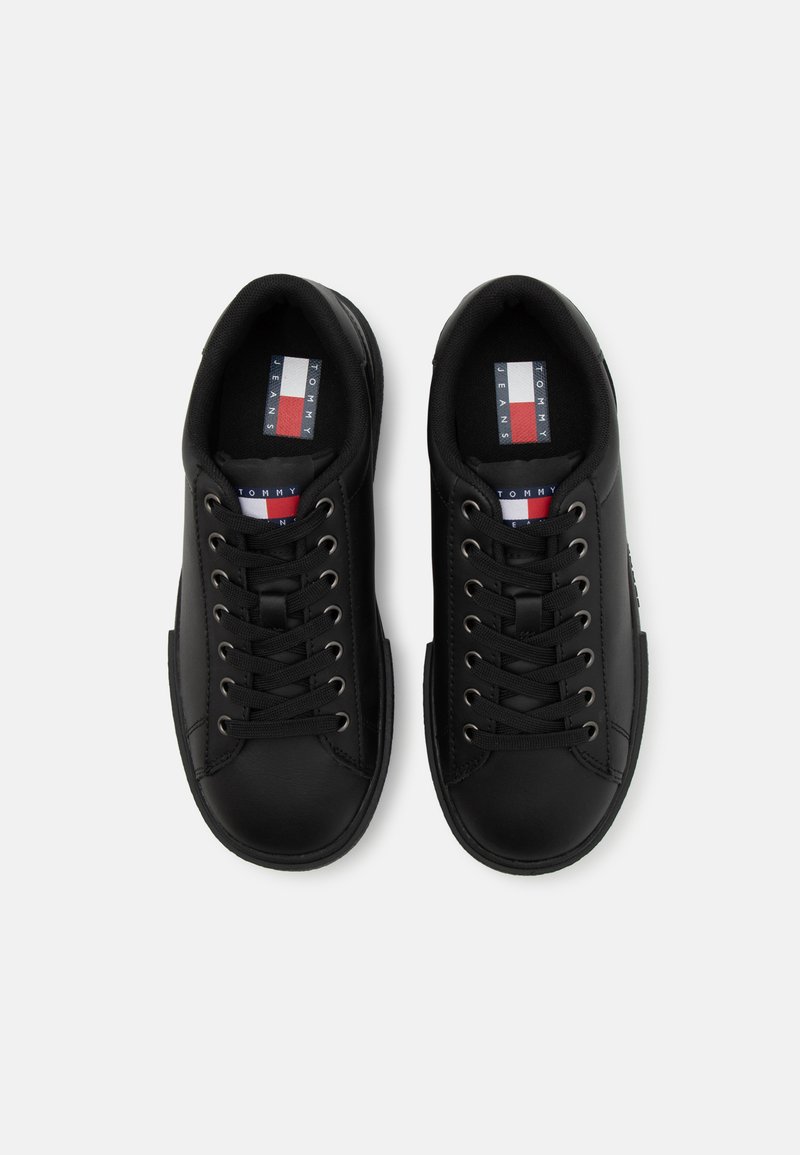 Czarne sneakersy na sznurówki wykonane z gładkiego materiału syntetycznego. Posiadają metalowe oczka oraz markowe wkładki z tkaniny z czerwonymi, białymi i niebieskimi akcentami.