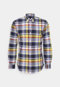 Rutigt skjorta med en blandning av gult, blått, rött och grönt. Tillverkad av vävd tyg med krage och lång ärm.