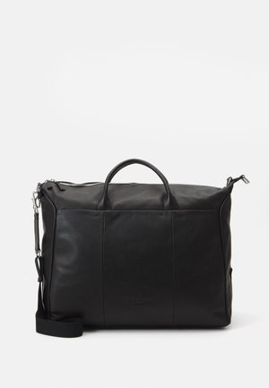 Black leather duffel bag with two top handles, a detachable shoulder strap, and zipper closure. Features flat seams and subtle branding.