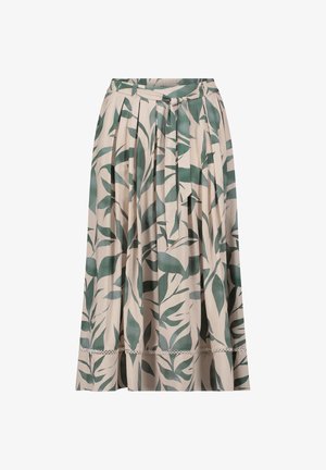Beiger plissierter Midirock mit dunkelgrünem Blattmuster, Taillengürtel und dekorativem Besatz nahe dem Saum.