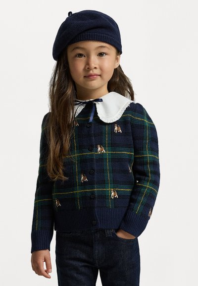 Navy svītrots kardigans ar zaļiem un dzelteniem akcentiem, ar izšūtām suņiem, baltu Peter Pan apkakli un pogu aizdari.