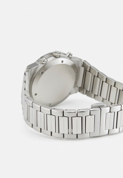 Silver stainless steel watch with a linked band, round case, and three push buttons on the side. Smooth, polished finish, minimalistic design.