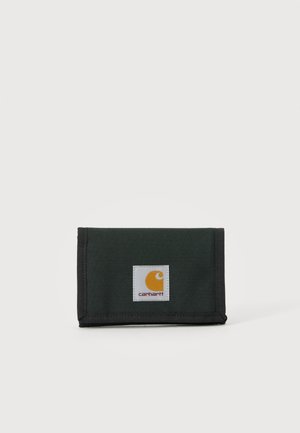 Black fabric Carhartt wallet with a rectangular white label showing a yellow logo and red text on the front, placed on a plain light background.