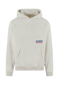 Light grey hoodie made from soft fabric. Features a front kangaroo pocket, ribbed cuffs and hem, and a small logo design on the chest.