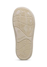 Semelle de chaussure en caoutchouc, couleur beige clair, texturée avec des motifs ondulés et un petit logo. Présente un talon rond et une conception flexible.