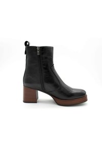 Bottine en cuir noir avec un bout arrondi, fermeture éclair sur le côté et tige texturée. Dotée d'un talon empilé marron pour plus de hauteur et de soutien.
