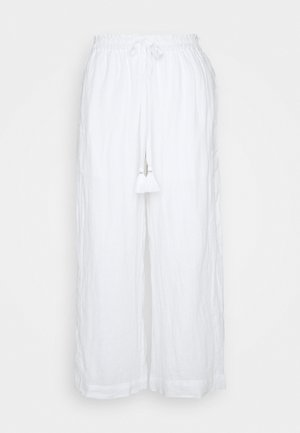 Bílé lněné kalhoty s volným střihem, elastickým pasem a šňůrkovým zapínáním, na přední straně se dvěma bílými třásněmi.