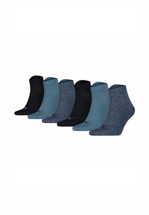 Six pairs of ankle socks in varying shades of blue and black, featuring ribbed cuffs, soft texture, and subtle branding on the sole.